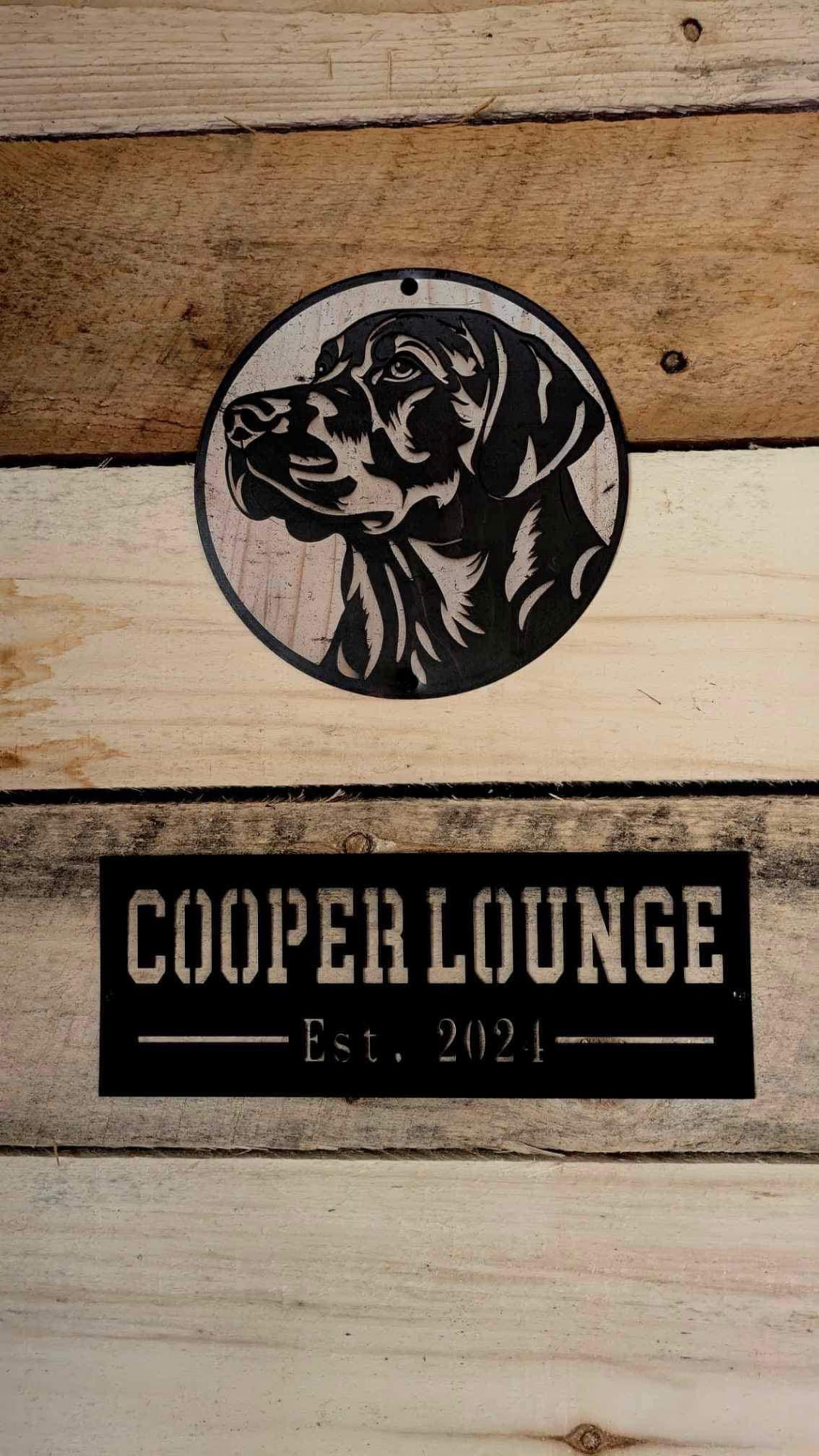 Cooper Lounge metal sign hanging on the barn wall